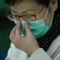 Hong Kong Chief Executive Carrie Lam adjusts protective face mask during a press conference held in Hong Kong, Tuesday, Jan. 28, 2020. Lam has announced that all rail links to mainland China will be cut starting Friday as fears grow about the spread of a new virus. (AP Photo/Vincent Yu)