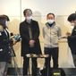 Wearing surgical masks, Takeo Aoyama, center left, and Takayuki Kato, center right, employees at Nippon Steel Corp.s subsidiary in Wuhan, China, speak to journalists after returning home by a Japanese chartered plane at Haneda international airport in Tokyo Wednesday, Jan. 29, 2020. Japan on Wednesday began evacuating their citizens from the Chinese city hardest-hit by an outbreak of a new virus. Aoyama said more than 400 Japanese people wishing to return to Japan are in Wuhan. (AP Photo/Haruka Nuga)