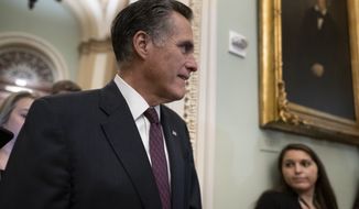 Sen. Mitt Romney, R-Utah, is questioned by reporters during the impeachment trial of President Donald Trump on charges of abuse of power and obstruction of Congress, at the Capitol in Washington, Tuesday, Jan. 28, 2020. (AP Photo/J. Scott Applewhite)
