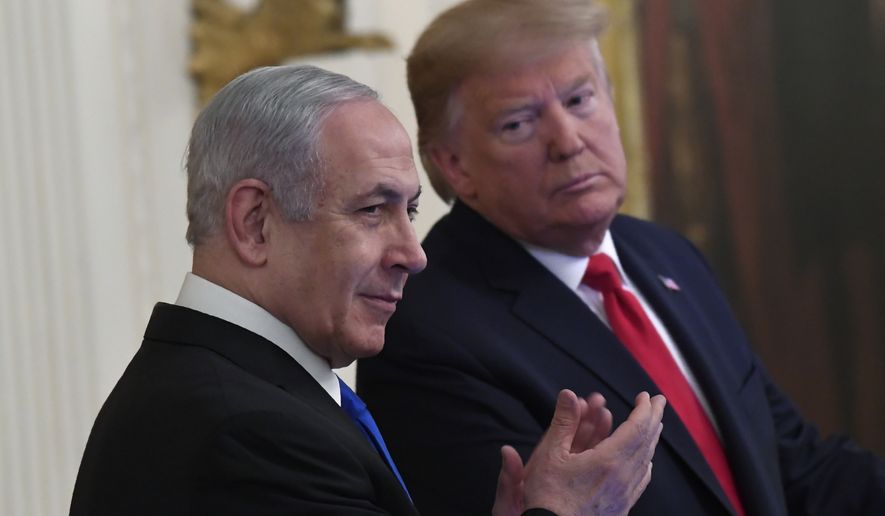 President Donald Trump, right, looks over to Israeli Prime Minister Benjamin Netanyahu, left, during an event in the East Room of the White House in Washington, Tuesday, Jan. 28, 2020, to announce the Trump administration&#39;s much-anticipated plan to resolve the Israeli-Palestinian conflict. (AP Photo/Susan Walsh)