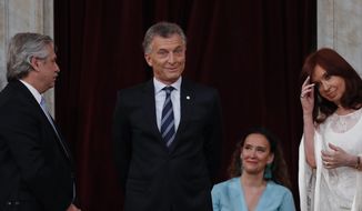 Outgoing president Mauricio Macri gestures before giving the presidential sash to new President Alberto Fernandez, left, at the Congress in Buenos Aires, Argentina, Tuesday, Dec. 10, 2019. At right is Vice President Cristina Fernandez de Kirchner. (AP Photo/Natacha Pisarenko)