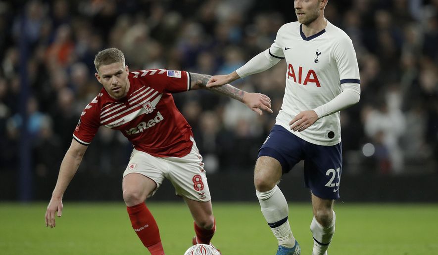 Middlesbrough&#x27;s Adam Clayton, left, and Tottenham&#x27;s Christian Eriksen challenge for the ball during the English FA Cup third round replay soccer match between Tottenham Hotspur and Middlesbrough FC at the Tottenham Hotspur Stadium in London, Tuesday, Jan. 14, 2020.(AP Photo/Matt Dunham)