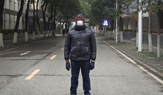 This Jan. 27, 2020, photo, provided by Dr. Khamis Hassan Bakari of Tanzania, shows him posing for a photo in Wuhan, China. Bakari is among more than 4,000 African students in the Chinese city of 11 million people, and has been sending updates on social media about the outbreak of a new virus to the more than 400 other Tanzanian students in Wuhan, as China’s astonishing lockdown of more than 30 million people continues. (Khamis Hassan Bakari via AP)