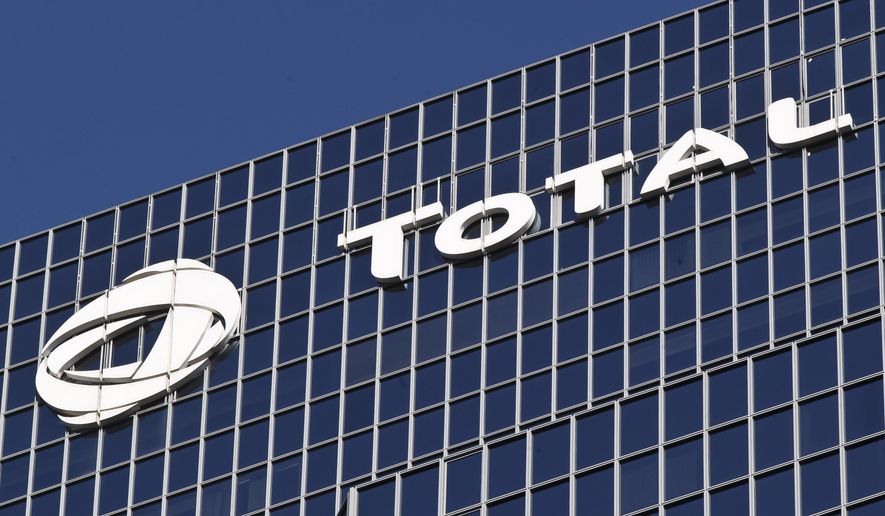 FILE - This Jan.11, 2016 file photo shows the logo of French oil giant Total SA on its headquarters at La Defense business district outside Paris. A partnership of French non-governmental organisations and over a dozen local authorities launched unprecedented legal action Tuesday against energy company Total, aimed at forcing it to drastically reduce its greenhouse gas emissions. (AP Photo/Michel Euler, File)