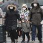 Chinese tourists wear masks at Ginza shopping district in Tokyo, Tuesday, Jan. 28, 2020. China has confirmed more than 4,500 cases of a new virus. Most have been in the central city of Wuhan where the outbreak began in December. More than 45 cases have been confirmed in other places with nearly all of them involving Chinese tourists or people who visited Wuhan recently. (AP Photo/Koji Sasahara)
