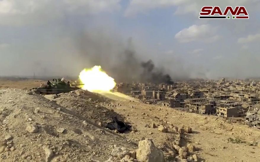 This file frame grab from a video released on Nov. 2, 2017, by the Syrian official news agency SANA shows a Syrian army tank firing during a battle against Islamic State militants in Deir el-Zour, Syria. The Islamic State group seemed largely defeated last year, with the loss of its territory, the killing of its founder in a U.S. raid and an unprecedented crackdown on its social media propaganda machine but tensions between the U.S. and Iran in the region provide a comeback opportunity for the extremist group. (SANA via AP, File)