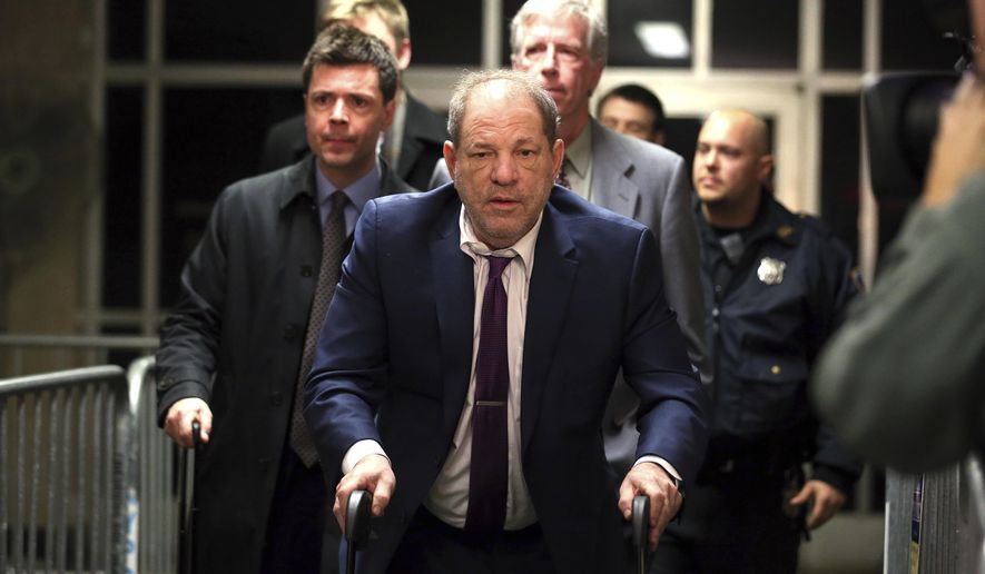 Harvey Weinstein, center, exits following his trial on charges of rape and sexual assault, Monday, Jan. 27, 2020, in New York. (AP Photo/Michael Owens)