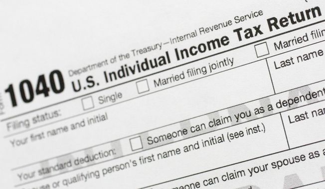 This July 24, 2018, file photo shows a portion of the 1040 U.S. Individual Income Tax Return form. (AP Photo/Mark Lennihan, File)