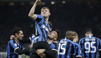 Inter Milan&#39;s Nicolo Barella, top, celebrates with his teammates after he scored his side&#39;s second goal during an Italian Cup quarter finals soccer match between Inter Milan and Fiorentina at the San Siro stadium, in Milan, Italy, Wednesday, Jan. 29, 2020. (AP Photo/Luca Bruno)