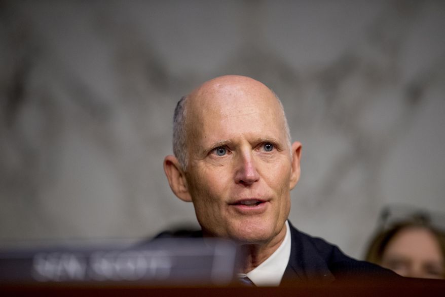 FILE - In this Nov. 5, 2019 file photo, Sen. Rick Scott, R-Fla., questions FBI Director Christopher Wray during a Senate Homeland Security Committee hearing on Capitol Hill in Washington.  Scott injected himself into the 2020 presidential race, airing an ad in Iowa days ahead before the crucial caucus by attacking the Democratic-led impeachment trial against President Donald Trump and accusing former Vice President Joe Biden of corruption. The ad buy by Scott was not just a volley into the current race, but also further signaled his ambitions for 2024 .(AP Photo/Andrew Harnik, File)