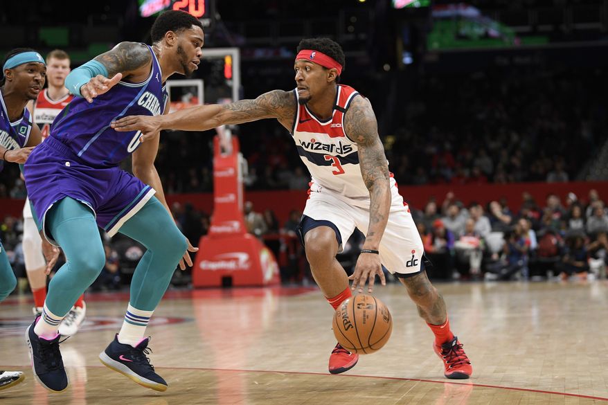 Washington Wizards guard Bradley Beal (3) drives to the basket next to Charlotte Hornets forward Miles Bridges (0) during the second half of an NBA basketball game, Thursday, Jan. 30, 2020, in Washington. (AP Photo/Nick Wass)