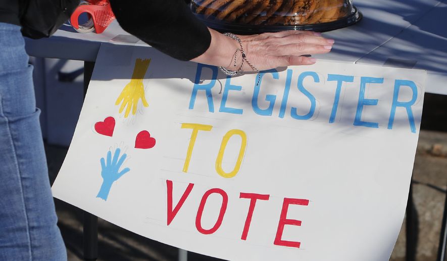 In this Jan. 18, 2020, file photo, a voting drive volunteer sets up a table in Richardson, Texas. Democrats are anxious about the coming presidential election and Republicans are more likely to be excited about it. That's the finding of a new poll from The Associated Press-NORC Center for Public Affairs Research. (AP Photo/LM Otero)