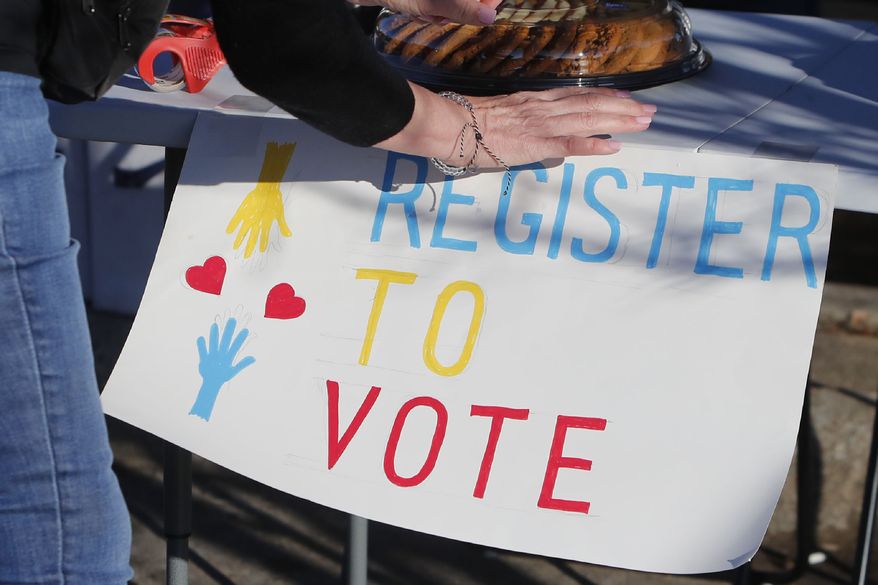 In this Jan. 18, 2020, file photo, a voting drive volunteer sets up a table in Richardson, Texas. Democrats are anxious about the coming presidential election and Republicans are more likely to be excited about it. That's the finding of a new poll from The Associated Press-NORC Center for Public Affairs Research. (AP Photo/LM Otero)