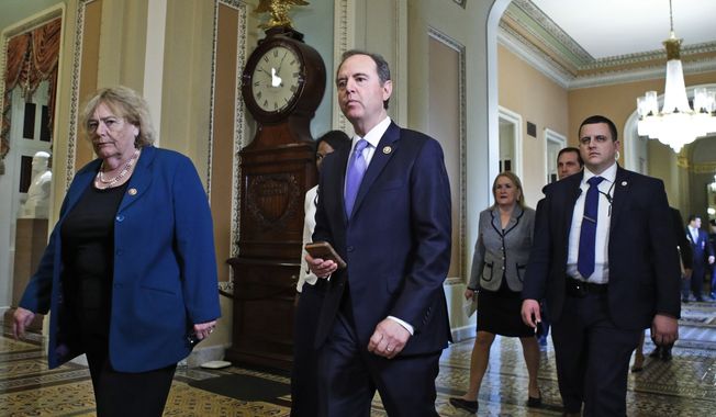 House Democratic impeachment managers Rep. Adam Schiff, D-Calif., center, and Rep. Zoe Lofgren, D-Calif., left, walk to the Senate chamber for the impeachment trial of President Donald Trump at the Capitol, Thursday, Jan. 30, 2020, in Washington. (AP Photo/Steve Helber)