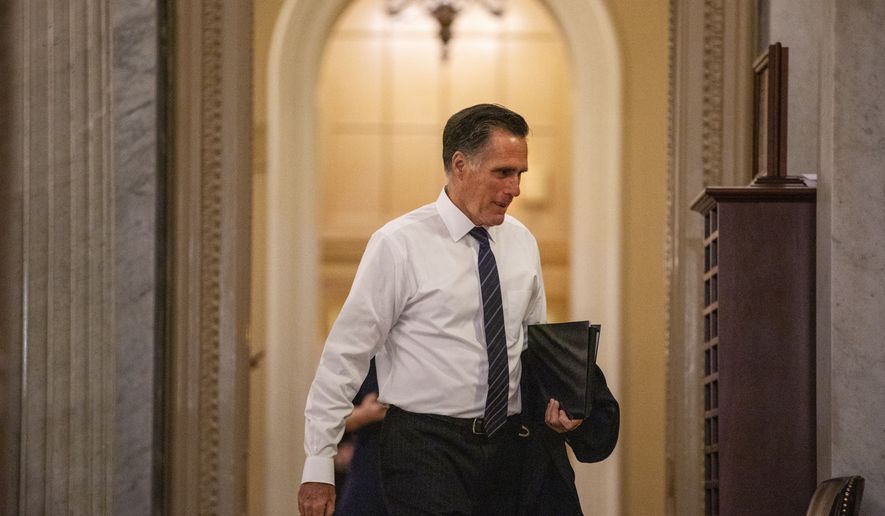 Sen. Mitt Romney, R-Utah, walks to the Senate chamber on Capitol Hill in Washington, Thursday, Jan. 30, 2020, during a break in the impeachment trial of President Donald Trump on charges of abuse of power and obstruction of Congress. (AP Photo/Jacquelyn Martin)