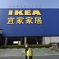 Workers walk past the entrance of a closed IKEA store in Hangzhou in eastern China&#39;s Zhejiang Province, Thursday, Jan. 30, 2020. The Swedish retailer announced then that it would temporarily shutter all of its stores in China amid a virus outbreak. (Chinatopix via AP) ** FILE **