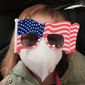 In this Tuesday, Jan. 28, 2020, file photo, Hermoine Dickey, 8, rides in a car on her way to Wuhan Tiange International Airport for a U.S. evacuation flight. Face masks are in short supply in parts of the world as people try to stop the spread of a new virus from China. Health officials recommend strap-on medical masks for people being evaluated for the new virus, their household members and caregivers. (Priscilla Dickey via AP, File) **FILE**