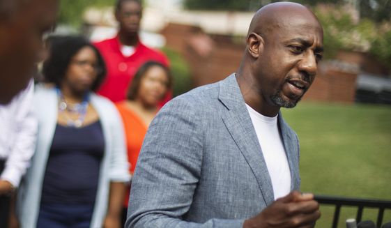Rev. Raphael G. Warnock, pastor of Ebenezer Baptist Church, right, speaks during a press conference after Confederate flags were found on the church&#39;s premises in Atlanta, July 30, 2015. Warnock announced his campaign for the U.S. Senate on Thursday, Jan. 30, 2020 challenging recently appointed Republican Kelly Loeffler. (AP Photo/David Goldman, File)  ** FILE ** 