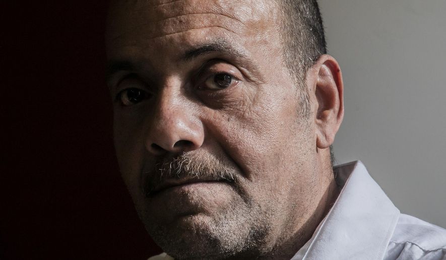 Rafael Ruiz, 60, sits in his lawyer's office at the Innocence Project, after his exoneration last Tuesday of a violent rape charge that sent him to prison for 25 years, Thursday Jan. 30, 2020, in New York. (AP Photo/Bebeto Matthews)