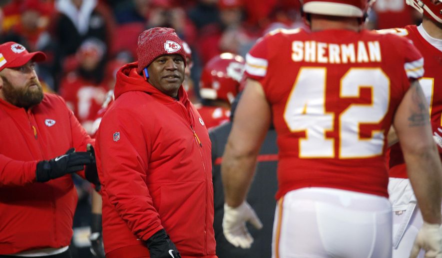 FILE - In this Jan. 20, 2019, file photo, Kansas City Chiefs offensive coordinator Eric Bieniemy watches players before the team's AFC championship NFL football game against the New England Patriots in Kansas City, Mo. The Chiefs have perhaps the most dynamic offense in the NFL and the San Francisco 49ers feature one of the stingiest defenses in the league. The men in charge of the units got interviews for head coaching but were passed over. (AP Photo/Charlie Riedel, File)