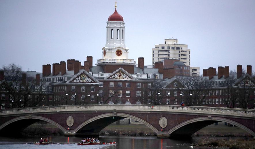 In this March 7, 2017 file photo, rowers paddle down the Charles River past the campus of Harvard University in Cambridge, Mass.  (AP Photo/Charles Krupa, File) **FILE**