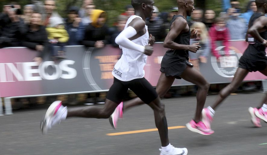 FILE - In this file photo dated Saturday, Oct. 12, 2019, Marathon runner Eliud Kipchoge from Kenya running the INEOS 1:59 Challenge to finish in 1:59:40 in Vienna, Austria, to become the first human ever to run a marathon under two hours. World Athletics published updated guidelines on Friday Jan. 31, 2020, which limited the use of prototype shoes like the high-tech Nike style worn in a sub-2 hour marathon run by Eliud Kipchoge in Vienna in October 2019. (AP Photo/Ronald Zak, FILE)