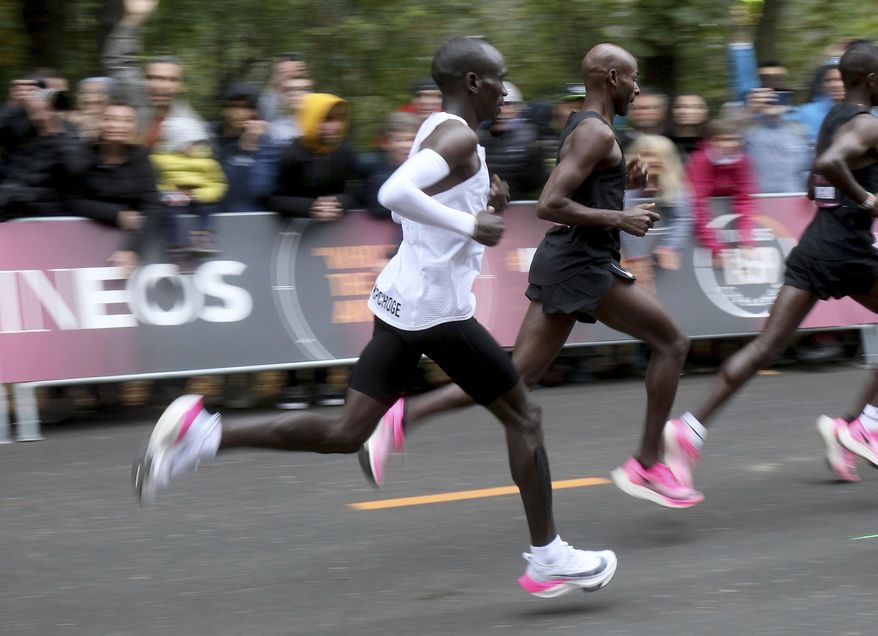 FILE - In this file photo dated Saturday, Oct. 12, 2019, Marathon runner Eliud Kipchoge from Kenya running the INEOS 1:59 Challenge to finish in 1:59:40 in Vienna, Austria, to become the first human ever to run a marathon under two hours. World Athletics published updated guidelines on Friday Jan. 31, 2020, which limited the use of prototype shoes like the high-tech Nike style worn in a sub-2 hour marathon run by Eliud Kipchoge in Vienna in October 2019. (AP Photo/Ronald Zak, FILE)