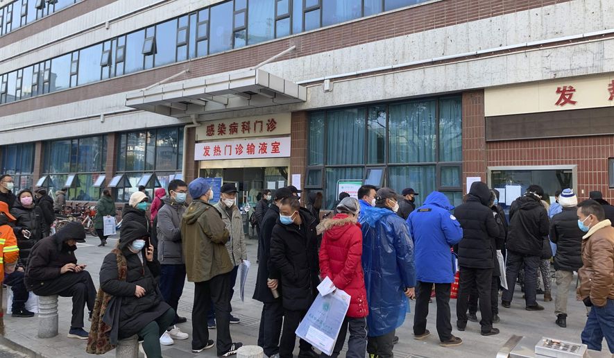 In this Friday, Jan. 31, 2020, photo, people line up outside a fever clinic at Wuhan Union Hospital in Wuhan in central China&#39;s Hubei Province. The United States on Friday declared a public health emergency and took drastic steps to significantly restrict entry into the country because of a new virus that hit China and has spread to other nations. (Chinatopix via AP)