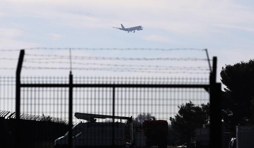 The plane carrying European passengers escaping Wuhan prepares to land at the military air base in Istres, southern France, Friday Jan.31, 2020. The passengers will be kept in quarantine for 14 days and will be put up at a southern vacation resort of Carry-le-Rouet. (AP Photo/Daniel Cole)