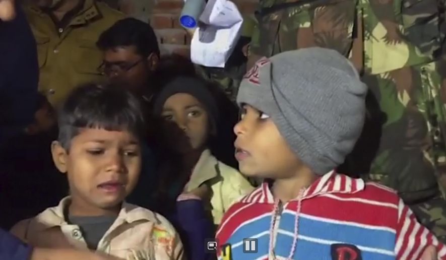 This Thursday, Jan. 30, 2020, frame grab from video provided by KK Productions shows children after they were rescued in Kasaria village in the northern Indian state of Uttar Pradesh. Authorities rescued 23 children after killing a man who held them hostage for nearly 11 hours after inviting them to his home for his daughter’s birthday party in northern India, police said Friday. (KK Productions via AP)