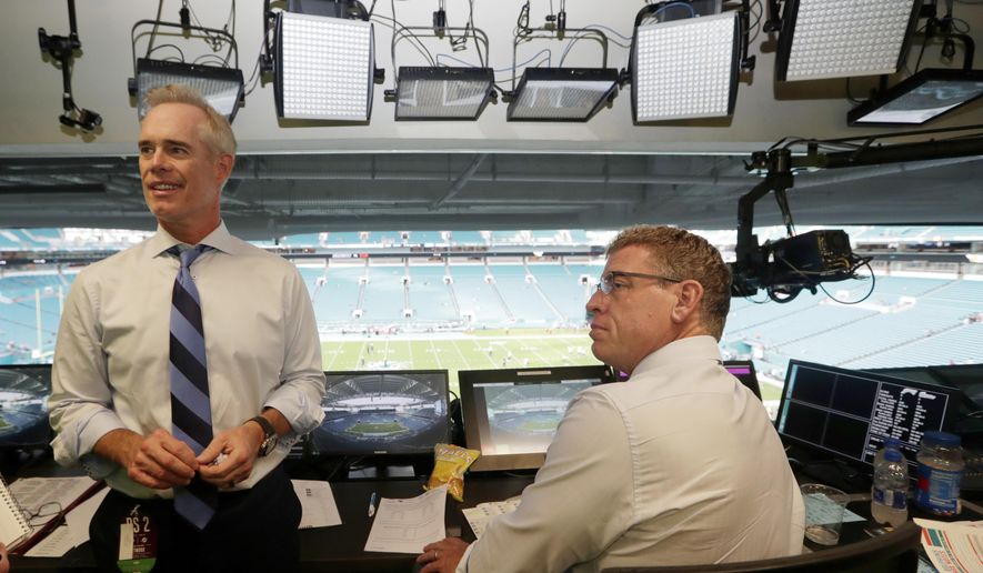FILE - In this Aug. 23, 2019, file photo, Fox Sports play-by-play announcer Joe Buck, left, and analyst Troy Aikman, right, work in the broadcast booth before a preseason NFL football game between the Miami Dolphins and Jacksonville Jaguars in Miami Gardens, Fla. Chris Myers and Erin Andrews will be doing a little bit of everything on the sidelines for Fox&#39;s broadcast of Super Bowl 54. Not only will they be filing reports, but will be the eyes and ears for the production truck as well as Joe Buck and Troy Aikman in the booth. (AP Photo/Lynne Sladky, File)
