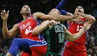 Boston Celtics&#39; Grant Williams, center, battles against Philadelphia 76ers&#39; Al Horford (42) and Tobias Harris, right, for a rebound during the first half of an NBA basketball game in Boston, Saturday, Feb. 1, 2020. (AP Photo/Michael Dwyer)