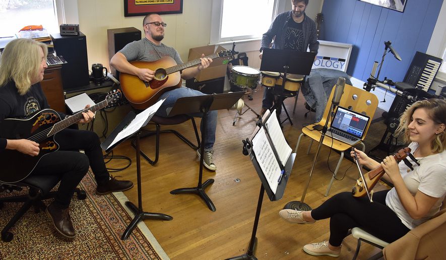 Doug Kees, David Puett, Jack Jones and Bahar Bingol Gjuka rehearse for a Musiki Flow concert at Musicology in Newnan, Ga. on Dec. 5, 2019. Gjuka spent five years in her native Turkey studying music for her undergraduate degree, but said she came to the realization that she wasn’t quite finished with her studies.(Rebecca Leftwich/The Newnan Times-Herald via AP)