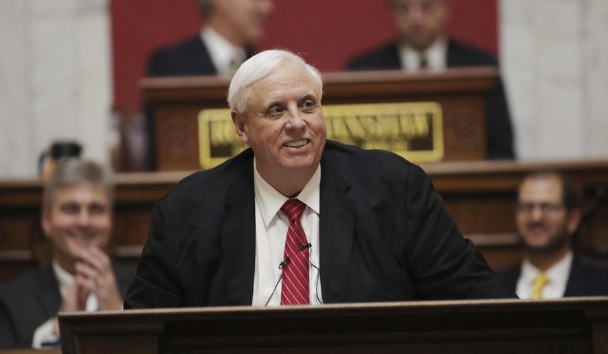 FILE - In this Jan. 8, 2020 file photo, West Virginia Governor Jim Justice delivers his annual State of the State address in the House Chambers at the state capitol in Charleston, W.Va. Justice on Tuesday, Jan. 28 endorsed a plan for conservatives unhappy with the new direction of their state legislature to demand ballot referendums in their cities and counties this November, through which they could express their desire for their county to leave Virginia and join West Virginia instead. (AP Photo/Chris Jackson, File)
