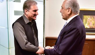 In this photo released by the Foreign Office, Pakistan&#39;s Foreign Minister Shah Mehmood Qureshi, left, meets U.S. envoy Zalmay Khalilzad at the Foreign Ministry in Islamabad, Pakistan, Friday, Jan. 31, 2020. Khalilzad has met with Pakistan&#39;s foreign minister to find a peaceful solution to neighboring Afghanistan&#39;s war. (Pakistan Foreign Office via AP)