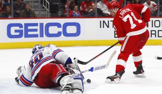 New York Rangers goaltender Henrik Lundqvist (30) stops a Detroit Red Wings center Dylan Larkin (71) shot in the second period of an NHL hockey game Saturday, Feb. 1, 2020, in Detroit. (AP Photo/Paul Sancya)