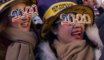 People celebrate the New Year in Times Square in New York, early Wednesday, Jan. 1, 2020, (AP Photo/Craig Ruttle)