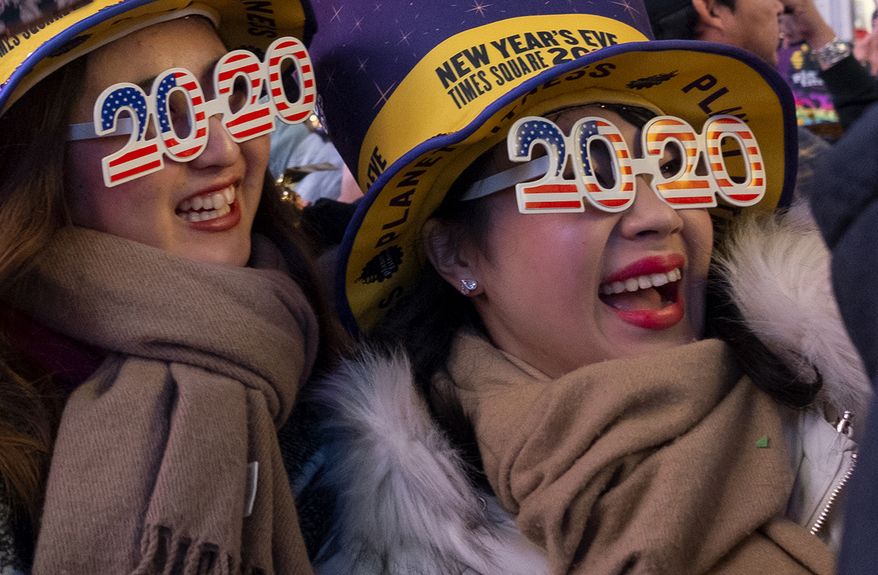 People celebrate the New Year in Times Square in New York, early Wednesday, Jan. 1, 2020, (AP Photo/Craig Ruttle)