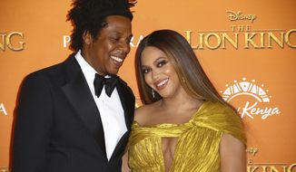 Singers Jay-Z, left, and Beyonce pose for photographers upon arrival at the &quot;Lion King&quot; European premiere in central London. (Photo by Joel C Ryan/Invision/AP, File)