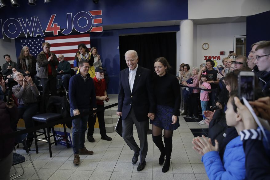 Democratic presidential candidate former Vice President Joe Biden, arrives to a campaign event with his granddaughter Finnegan Biden, Sunday, Feb. 2, 2020, in Dubuque, Iowa. (AP Photo/Marcio Jose Sanchez)