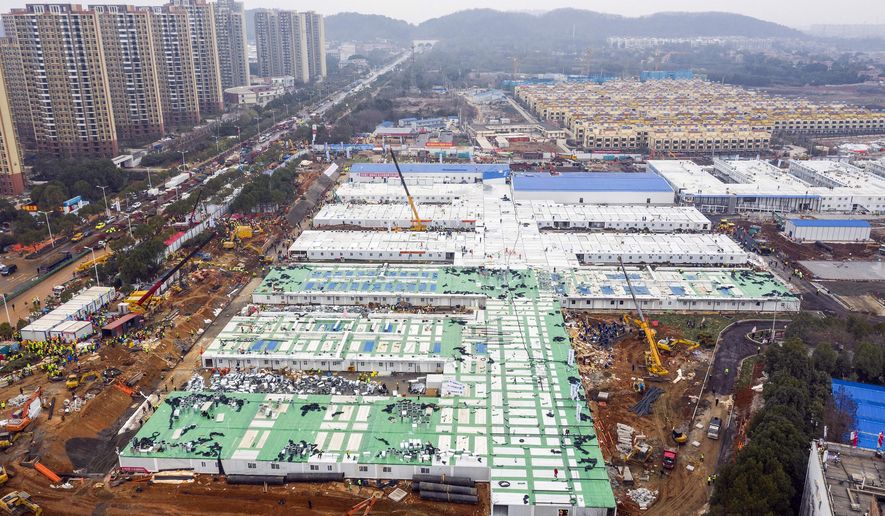The Huoshenshan temporary field hospital under construction is seen as it nears completion in Wuhan in central China's Hubei Province, Sunday, Feb. 2, 2020. The Philippines on Sunday reported the first death from a new virus outside of China, where authorities delayed the opening of schools in the worst-hit province and tightened quarantine measures in a city that allow only one family member to venture out to buy supplies. (Chinatopix via AP)
