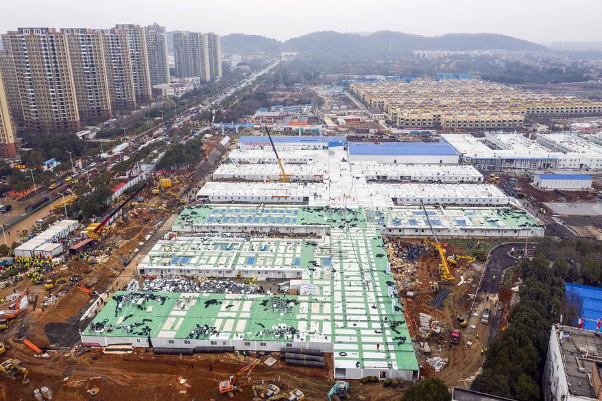The Huoshenshan temporary field hospital under construction is seen as it nears completion in Wuhan in central China's Hubei Province, Sunday, Feb. 2, 2020. The Philippines on Sunday reported the first death from a new virus outside of China, where authorities delayed the opening of schools in the worst-hit province and tightened quarantine measures in a city that allow only one family member to venture out to buy supplies. (Chinatopix via AP)