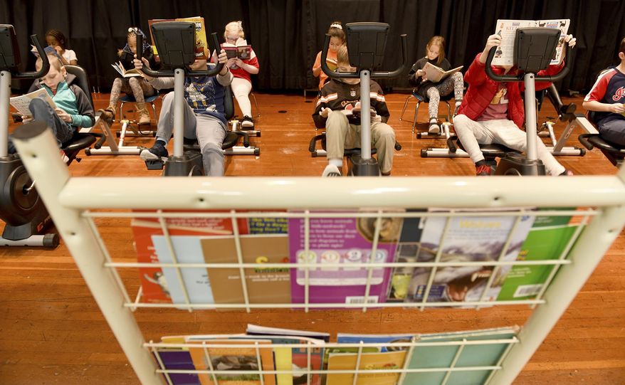 In this Monday, Jan. 13, 2020 photo, students participate in Read and Ride at Middlebranch Elementary School in Plain Township, Ohio. (Julie Vennitti/The Canton Repository via AP)