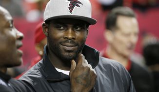 FILE - In this Jan. 1, 2017, file photo, former Atlanta Falcons quarterback Michael Vick stands on the sidelines before NFL football game between the Falcons and the New Orleans Saints in Atlanta. The former Virginia Tech and NFL quarterback is the subject of the latest edition of ESPN’s “30 for 30” documentary series.   (AP Photo/John Bazemore, File)