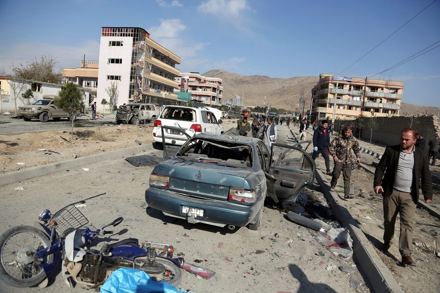 In this Wednesday, Nov. 13, 2019, file photo, Afghan security personnel gather at the site of a car bomb attack in Kabul, Afghanistan.  (AP Photo/Rahmat Gul, File) **FILE**