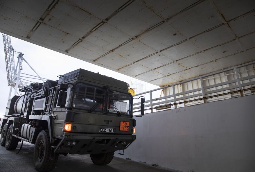 A military truck is unloaded from a British naval vessel, taking part in U.S.-led war games, at the Port of Antwerp in Antwerp, Belgium, Monday Feb. 3, 2020. The Defender-Europe 2020 exercises will involve approximately 20,000 American troops; the biggest deployment of U.S.-based soldiers to Europe in 25 years. (AP Photo/Virginia Mayo)
