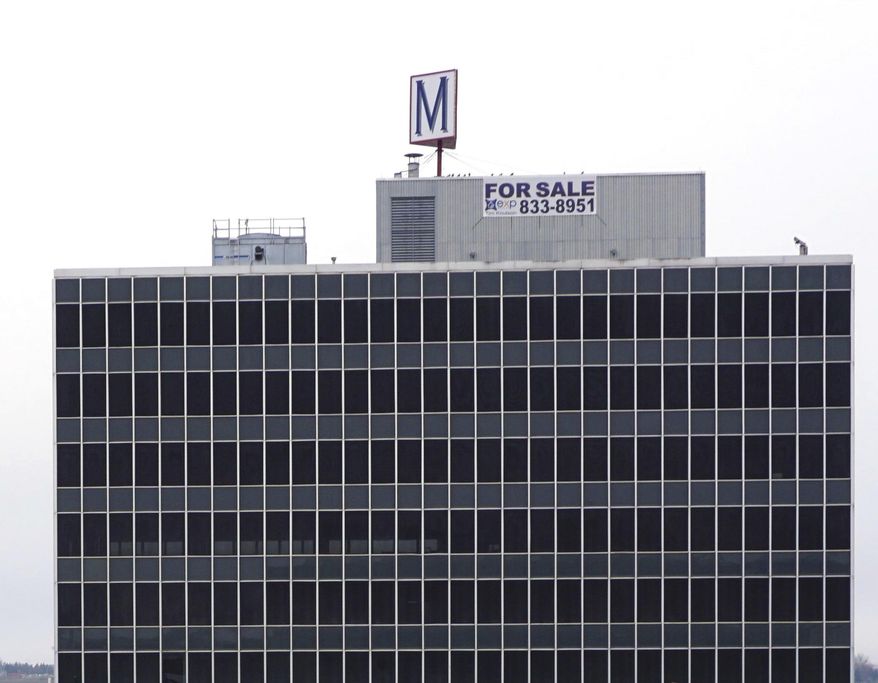 This Nov. 15, 2019 photo shows the former Midwest Federal bank building is known as the M Building in Minot, N.D. The big M on its roof established the eight-story former Midwest Federal Savings Bank as a Minot landmark, and many memories were made by folks who entered the building’s doors over the past 57 years. (Jill Schramm/Minot Daily News via AP)