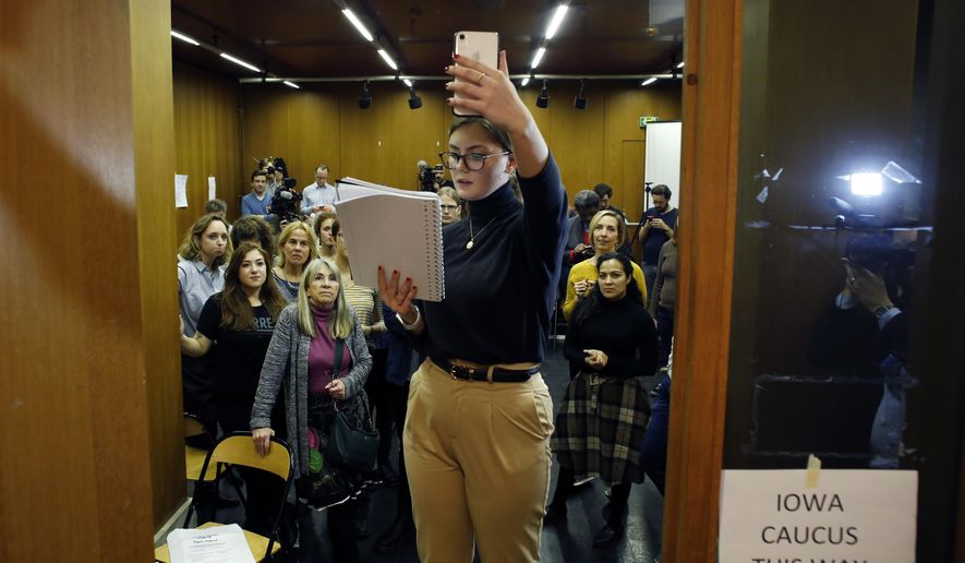 Emily Hagedorn, center, gives a phonecall to announce the election results, in Paris, Monday, Feb. 3, 2020. Paris is one of just three satellite caucus locations outside the U.S., and drew the biggest number of expat Iowans. (AP Photo/Thibault Camus)