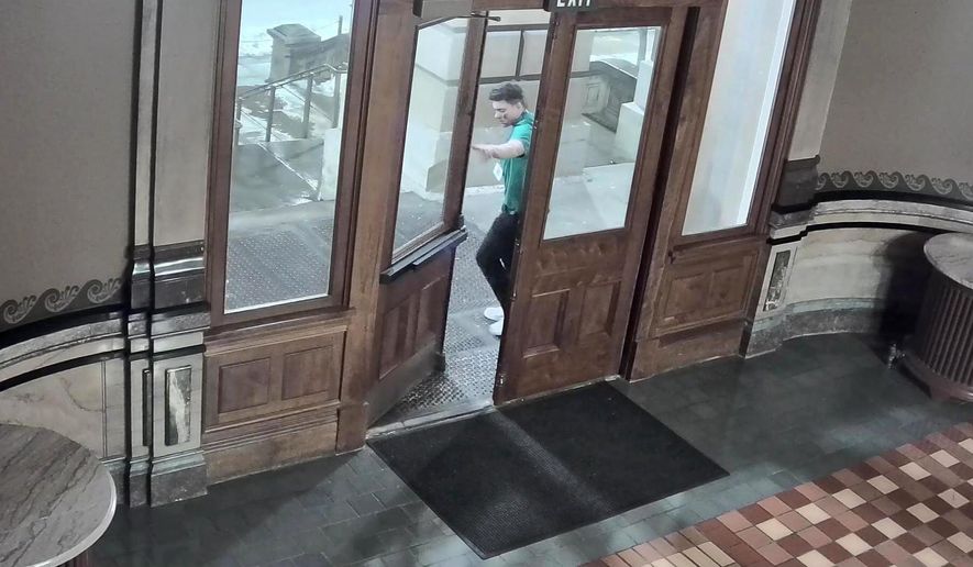 Surveillance cameras recorded images provided by the Iowa Department of Public Safety shows a man breaking into the Iowa Capitol early Sunday, Feb. 2, 2020. The man caused some damage, authorities said. (Iowa Department of Public Safety via AP)