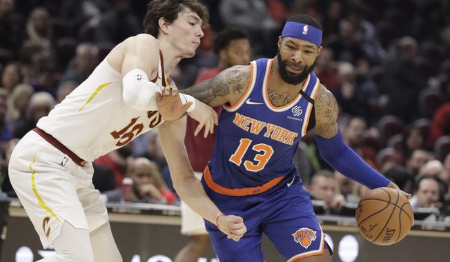 New York Knicks&#x27; Marcus Morris Sr. (13) drives to the basket against Cleveland Cavaliers&#x27; Cedi Osman (16) in the second half of an NBA basketball game, Monday, Feb. 3, 2020, in Cleveland. New York won 139-134 in overtime. (AP Photo/Tony Dejak)